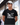 Man wearing a black t-shirt with 'The Grill Father' design outdoors.